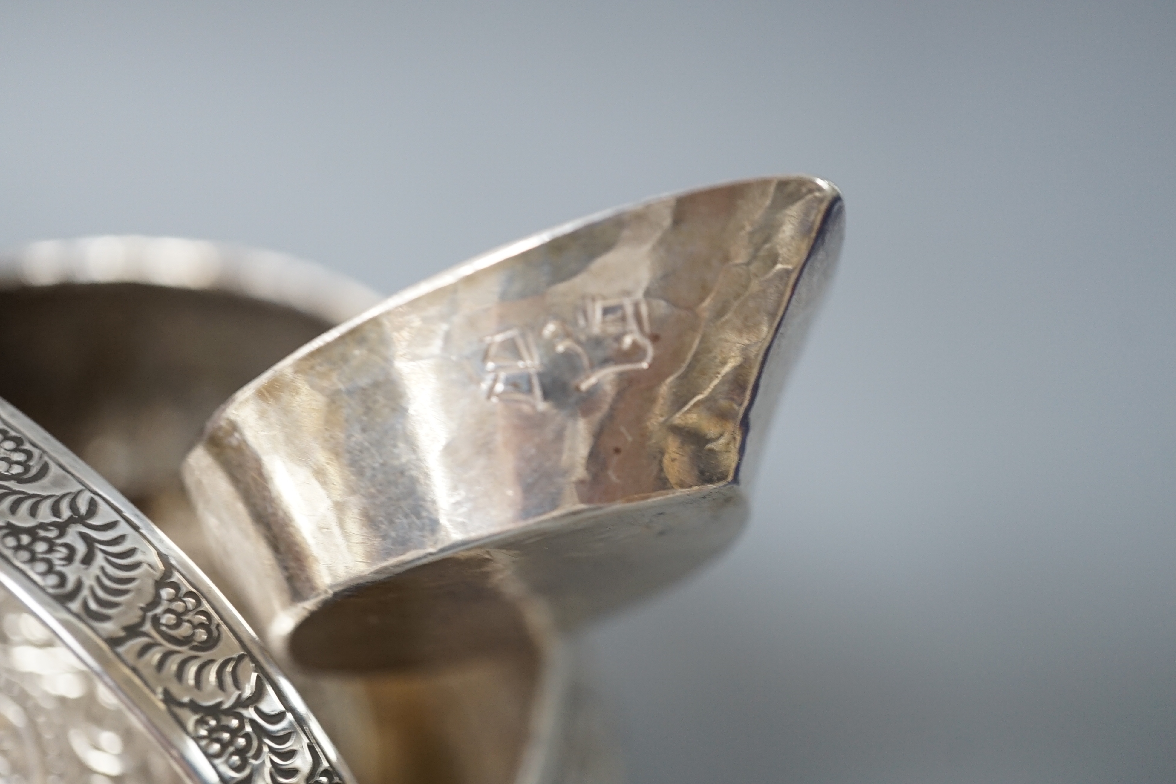 A Burmese? white metal bonbon basket, height 10.1cm and a similar bowl, two Persian white metal boxes and a spoon.